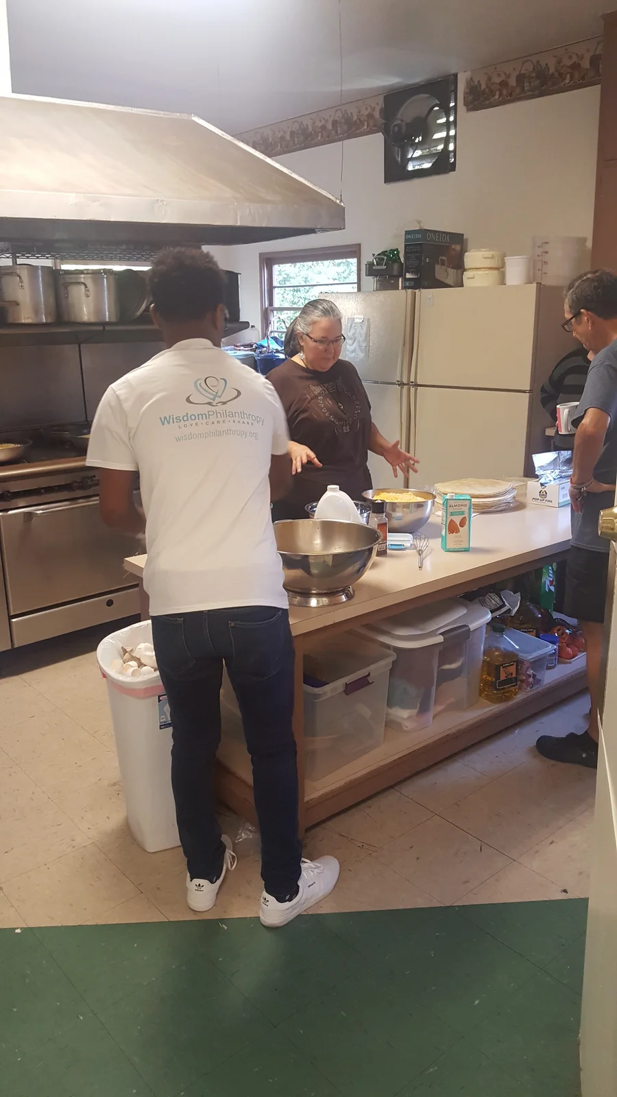 Adults preparing food at a kitchen counter.